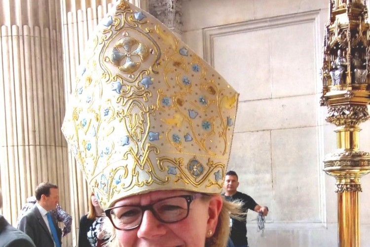 Female bishop wearing ceremonial mitre during installation ceremony