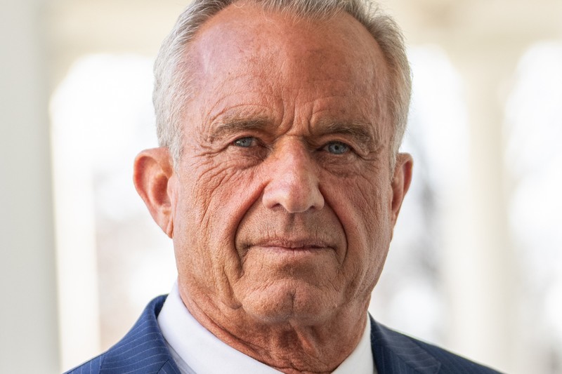 Portrait of Robert Malone in a blue pinstripe suit