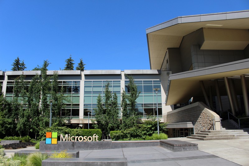Building 92 at Microsoft Corporation headquarters in Redmond, Washington, on a sunny day with the Microsoft logo visible in the foreground.