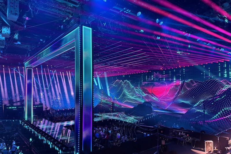 The Eurovision Song Contest 2025 stage in Basel, Switzerland, illuminated with vibrant LED displays and lighting effects