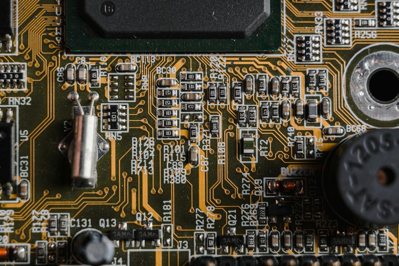 Close-up of a printed circuit board with intricate electronic components and copper traces