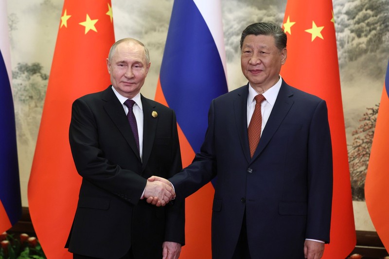 Vladimir Putin and Xi Jinping shake hands at the Great Hall of the People in Beijing during Putin's state visit to China.